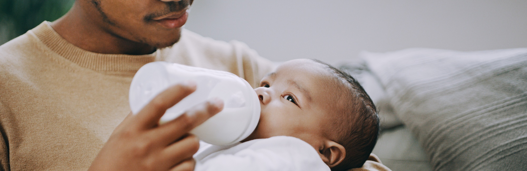 father bottle feeding child