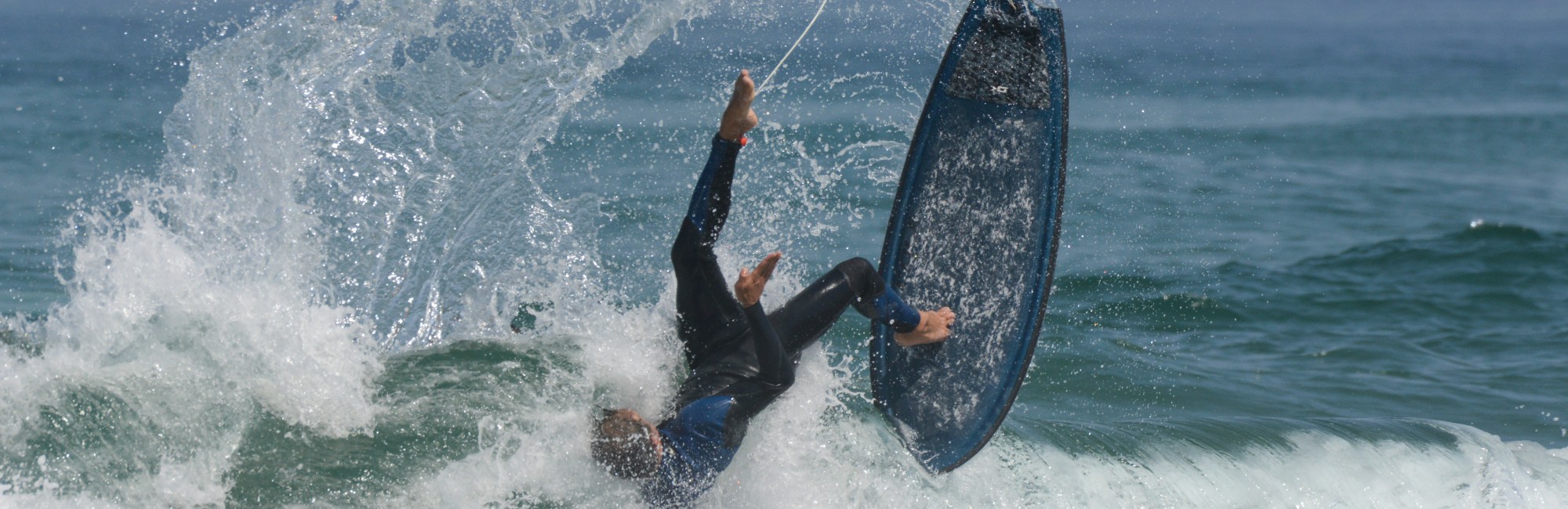 surfer falling off surfboard