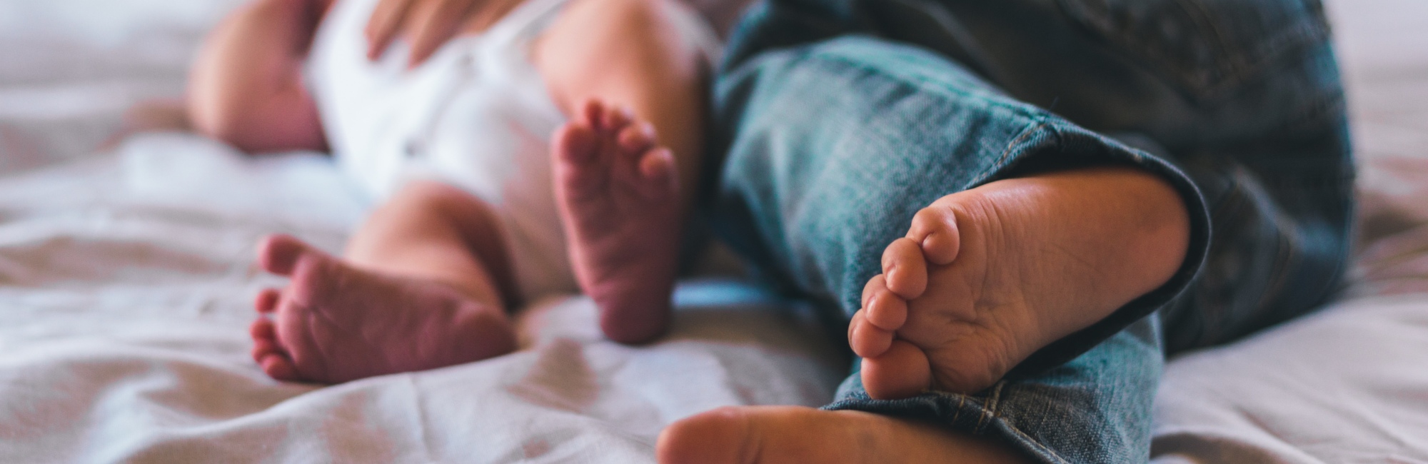 mother and baby cuddling in bed