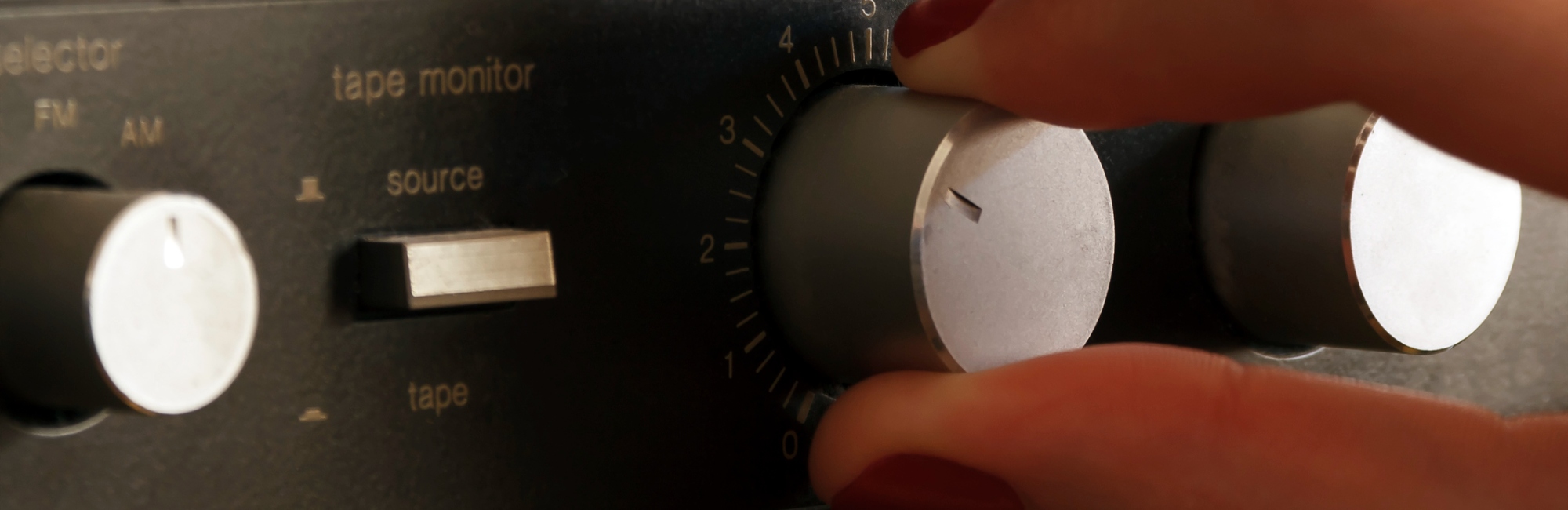 fingers turning dial on electronic device