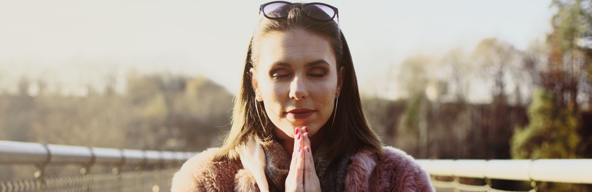 woman meditating on bridge