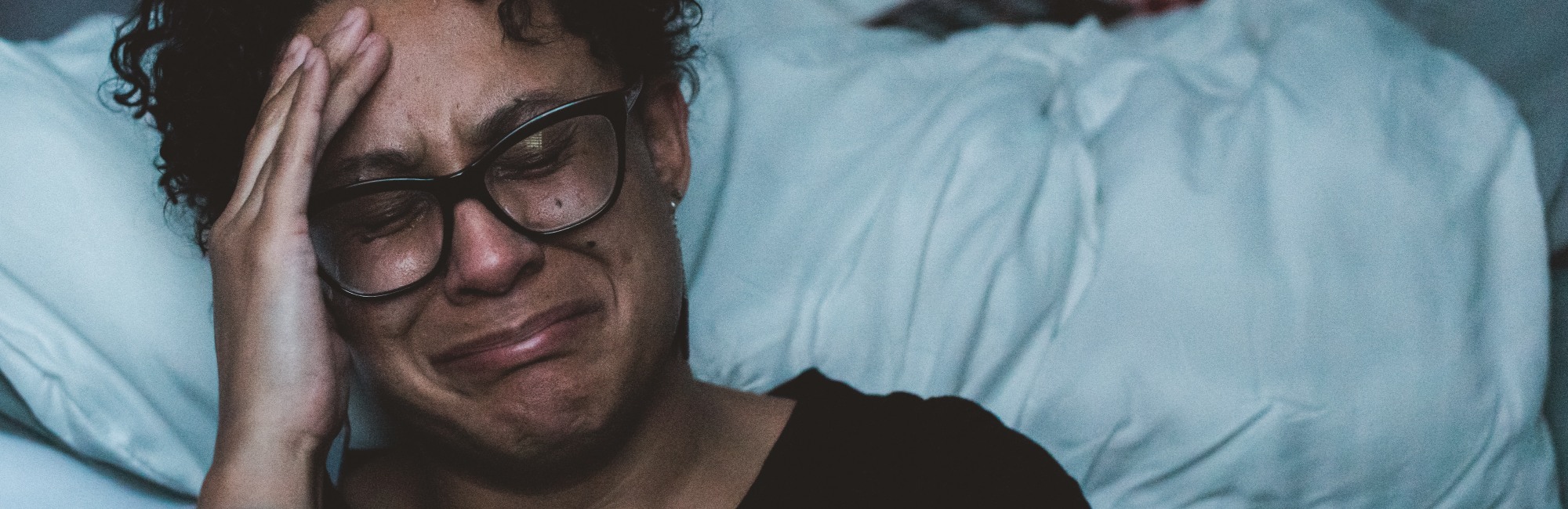 Upset woman by bed