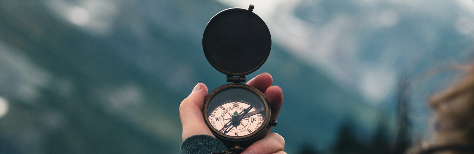 hand holding compass